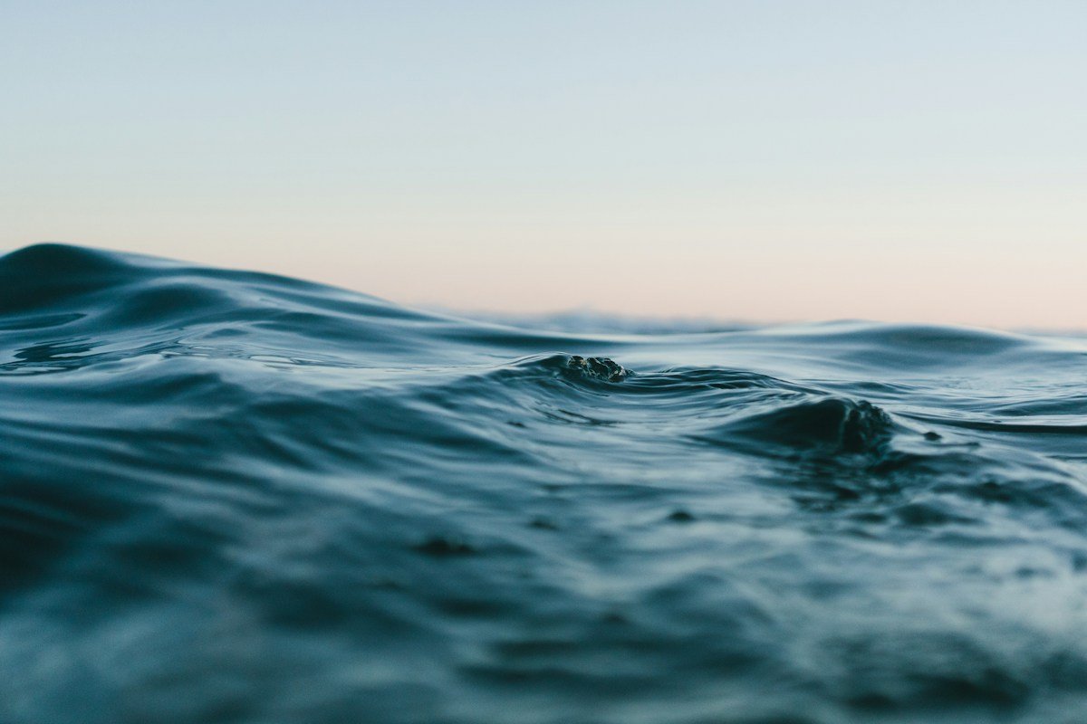 Sunlight falling across rolling ocean waves